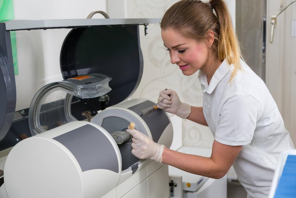 dental professional using CEREC machine to create crown
