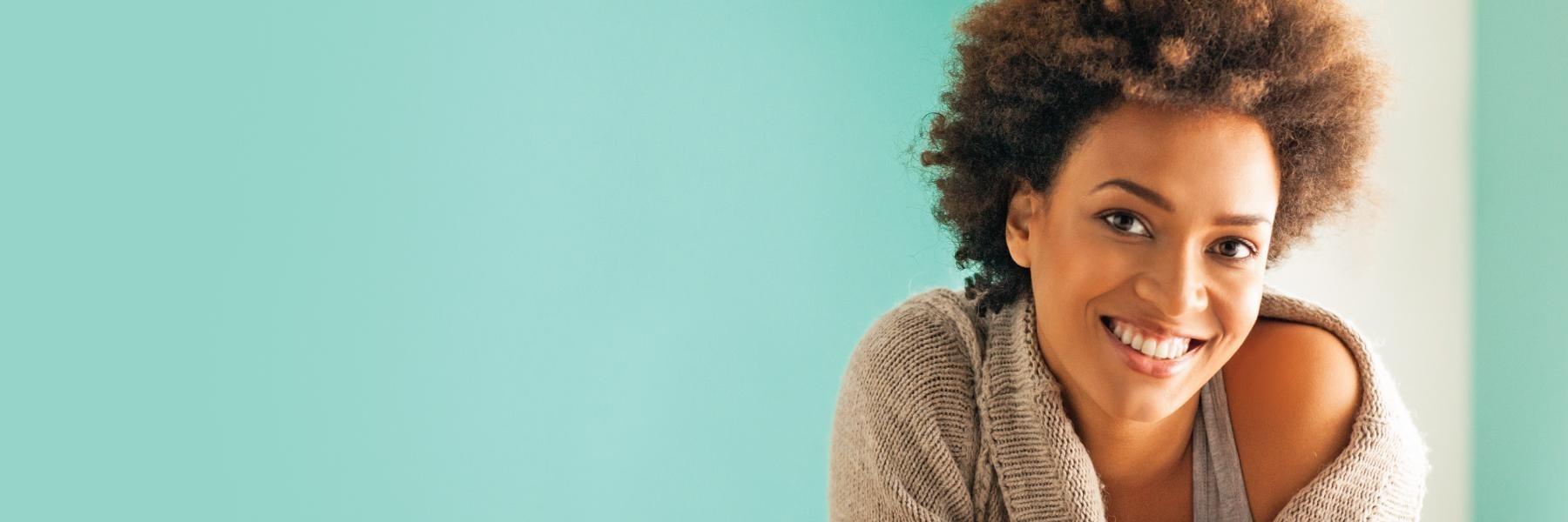 woman smiling after getting cosmetic dentistry