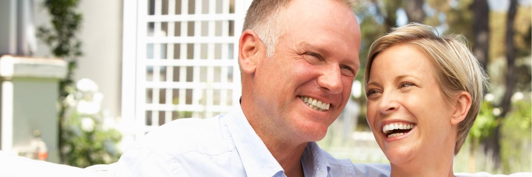 middle-aged man and woman smiling 