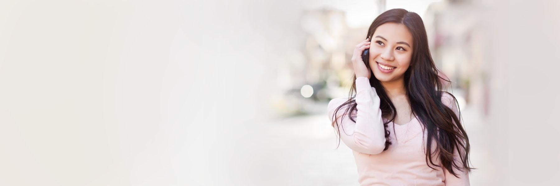 woman calling dentist on cell phone during a dental emergency