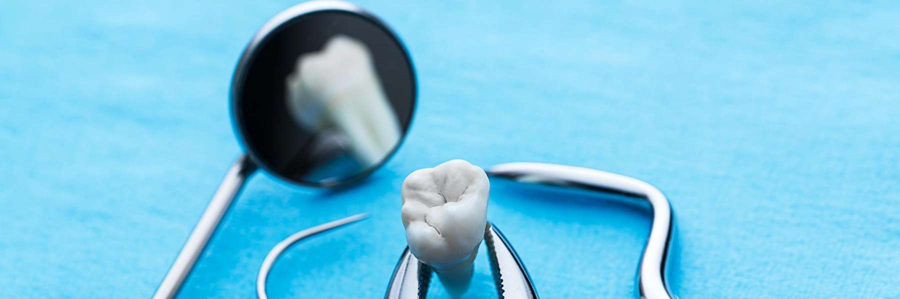 A dental mirror and a tooth in West Allis, WI