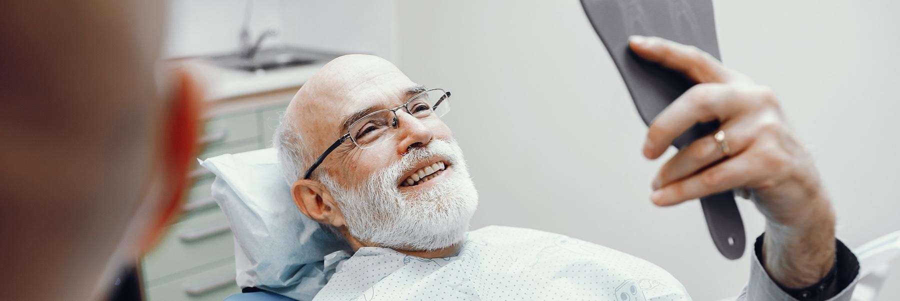 An elderly man getting dental implant in West Allis, WI