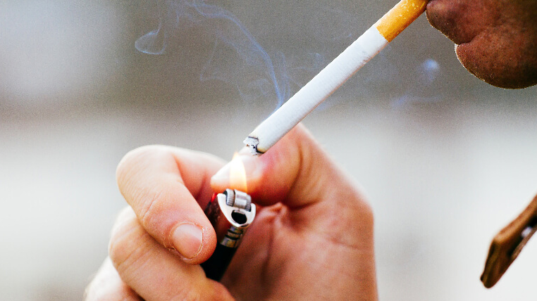 Close up of person lighting a cigarette