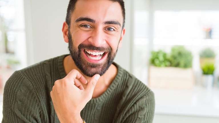 A man smiling after getting a smile makeover in Milwaukee, WI