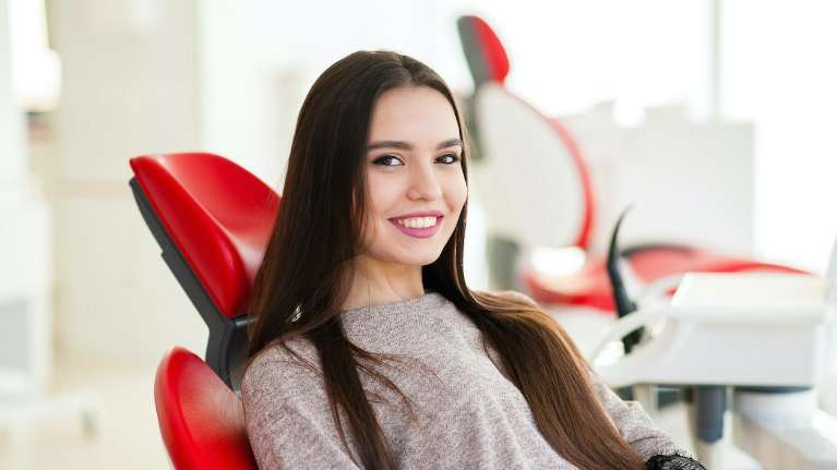 A lady smiling after dental check up in West Allis, WI.
