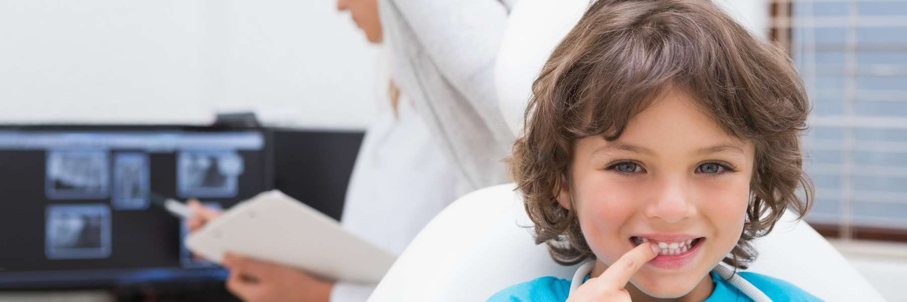 A child touching his teeth after dental check up in West Allis, WI.