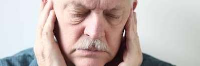 A patient holding his jaw due to toothache at Wisconsin smile, Milwauke