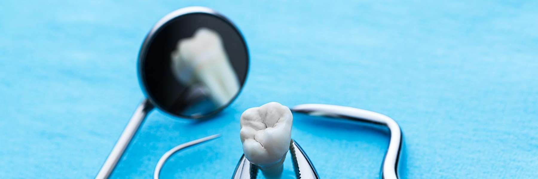 A dental mirror and a tooth model in West Allis
