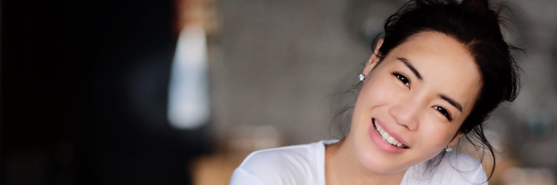 woman smiling after getting TMJ for botox