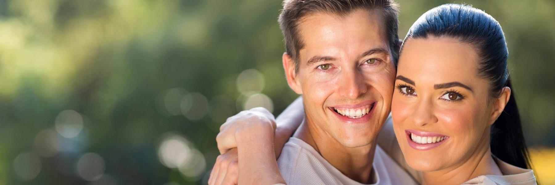 man and woman smiling after laser dentistry